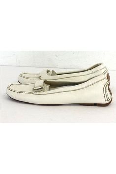 Size 6 EU 36 White Leather Loafers Made in Italy Strap & twist buckle design Silver tone hardware Removable insoles Outsole length 10" Classic Loafers With Buckle Closure For Spring, White Loafers With Stitched Sole, Summer Slip-on Loafers With Buckle Closure, Spring Slip-on Loafers With Buckle Closure, Spring Buckle Closure Slip-on Loafers, White Moccasins With Branded Insole, Casual Flat Loafers With Buckle Closure, Casual Office Loafers With Buckle Closure, Design Silver