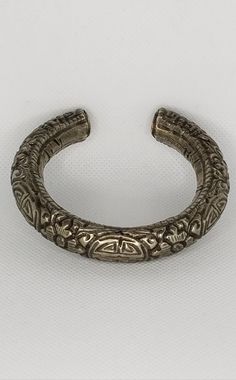 This hollow silver chased bracelet is from China and was made sometime in the mid 20th century. 7 inches inside circumference including gap, which is about 1.5 inches. The inside width is approximately 2.5 inches. This chased bracelet is hollow, with grains of sand inside, and weighs approximately 48 grams. Silver Etched Round Bracelets, Antique Silver Etched Cuff Bangle, Silver Etched Cuff Bracelet, Etched Metal Bracelet Bangle, Antique Silver Etched Bangle Bracelet, Antique Silver Hand Cast Bracelets, Antique Silver Hand-cast Bracelets, Antique Silver Etched Bracelets, Carved Silver Bangle For Formal Occasions