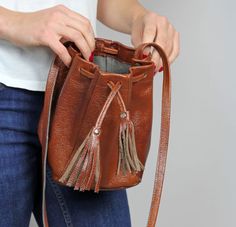 Mini Leather Bucket bag - caramel brown drawstring bag. Unlined The 35.5 inch (90 cm) strap has no adjustment. Cheap Party Shoulder Bucket Bag, Cheap Cream Pouch Bucket Bag, Brown Pouch Bucket Bag For Gift, Small Bucket Bag, Leather Waist Bag, Small Buckets, Drawstring Bucket Bag, Leather Fanny Pack, Brown Leather Shoulder Bag