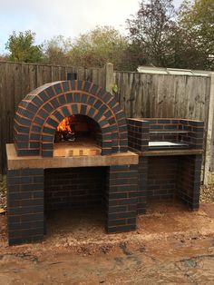 an outdoor brick pizza oven in the backyard