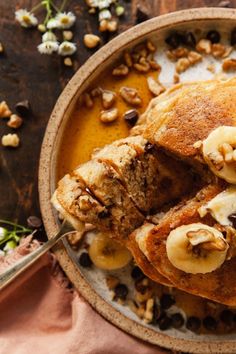 chocolate chip banana pancakes in a bowl with nuts on the side and text overlay that reads, chocolate chip banana pancakes