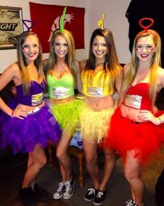 four girls dressed up in costumes posing for the camera with their hands on their hipss