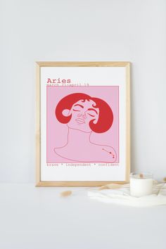 a pink poster with the words aries on it next to a glass of milk