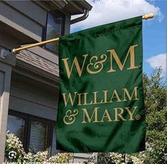 a green and gold flag with the words w & m and william and mary on it