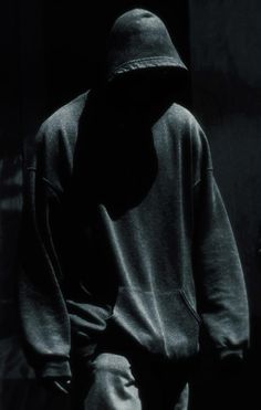 black and white photograph of a person in a hoodie with his back to the camera