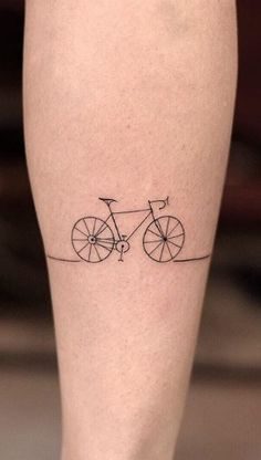 a small tattoo on the leg of a person with a bike drawn on it's side