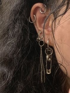 a close up of a person's ear with chains attached to the back of it