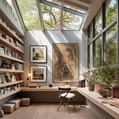 a home office with lots of bookshelves and pictures on the wall above it