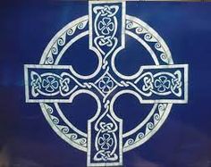 a blue and white cross on the side of a building with an intricate design in it