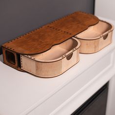 two wooden cases sitting on top of a white counter