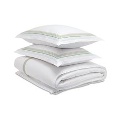 three pillows stacked on top of each other with white sheets and green trimmings