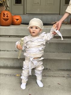 a little boy dressed up as a baby in a costume