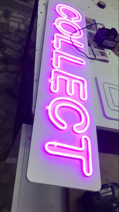 a neon sign that is on top of a table