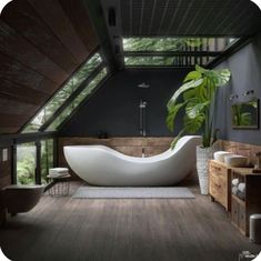 a large white bath tub sitting inside of a bathroom next to a wooden flooring