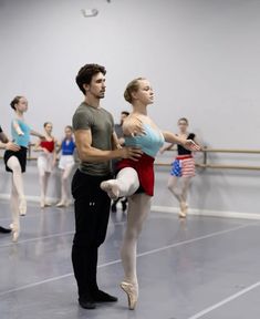 a man and woman are dancing in a dance studio