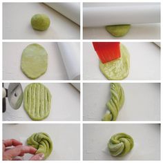 the process of making green cookies is being made by rolling dough into spirals and using a red brush