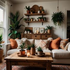 a living room filled with lots of plants on top of a wooden table next to a window