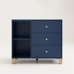 a blue cabinet with three drawers on one side and two gold knobs on the other