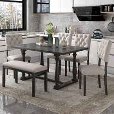 a dining room table with chairs and a bench in front of the kitchen countertop