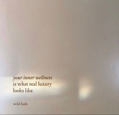 a white wall with a quote on it that says, your inner wellness is what real luxury looks like