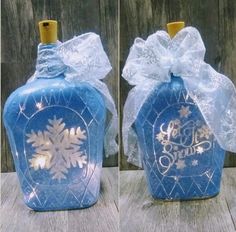 two bottles with snowflakes on them are shown side by side, one is blue and the other is white