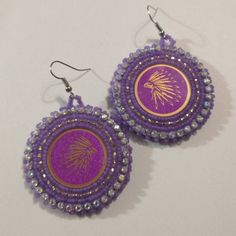 Hand made beaded earrings.  Colors: Purple & Gold Closure: Hook size: 2 inches Large Beads Dangle Jewelry Gift, Large Beads Dangle Jewelry For Gifts, Dangle Jewelry With Large Beads As Gift, Handmade Purple Earrings For Festive Occasions, Festive Handmade Purple Earrings, Colorful Beaded Adjustable Earrings As Gift, Festive Beaded Hoop Earrings With Round Beads, Festive Beaded Hoop Earrings, Adjustable Colorful Beaded Earrings As Gift