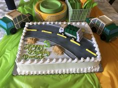 there is a birthday cake with a train on the side and other decorations around it