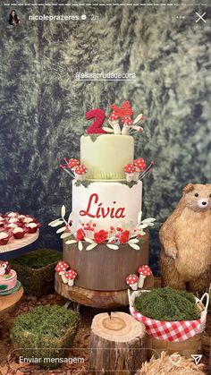 an image of a birthday cake with animals on the table and trees in the background