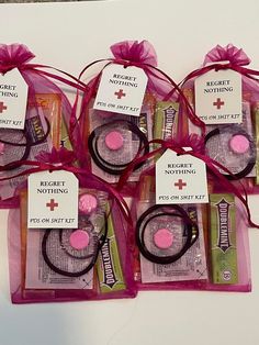 six pieces of pink and black hair ties in clear bags with tags on the top