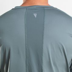 the back of a man's shirt showing his long sleeves and chest, in grey