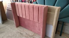 a pink headboard sitting next to a blue chair