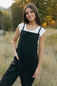 Introducing our Callum Overalls in black! Featuring a relaxed fit, adjustable straps, and front pockets, these overalls are both stylish and functional. The raw hem detail along the sides and back add an edgy touch, while the cinched sides offer even more detail. Perfect for your everyday look! *Relaxed fit* Material Content: 60% Cotton // 40% Polyester Material Pattern: Solid Kirsten is 5'4" wearing a small Model measurements: Kirsten: Height: 5'4" // Chest: 32" // Waist: 24" // Hips: 27" Amand Black Overalls With Suspenders, Black Overalls With Adjustable Straps For Summer, Black Summer Overalls With Adjustable Straps, Black Bib Front Utility Overalls, Black Utility Overalls With Bib Front, Black Cotton Overalls With Suspenders, Black Utility Overalls With Side Pockets, Utility Overalls With Adjustable Straps For Everyday, Everyday Utility Overalls With Adjustable Straps