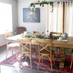 a dining room table with chairs and a rug