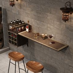 two wooden stools sitting next to a table with bottles and glasses on it in front of a brick wall