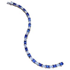 Sapphire and Diamond Line Tennis Bracelet in Platinum Sapphire and Diamond Line Bracelet features Sixteen Oval Sapphires of medium blue color and Sixteen Emerald Cut Diamonds set in Platinum. Total sapphire weight is 9.60 carats. Total diamond weight is 5.39 carats. Bracelet measures 7.5 inches long. Bracelet weighs 29.4 grams. Set in Platinum. Marked Plat, S9.60, D5.39 BUY WITH CONFIDENCE Authenticity is guaranteed for every item we sell. Long Bracelet, Emerald Cut Diamond, Emerald Cut Diamonds, Tennis Bracelet, Color Azul, Emerald Cut, Medium Blue, Diamond Cuts, Platinum