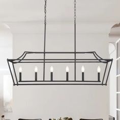 a chandelier hanging over a dining room table