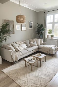 a living room filled with furniture and a large white rug on top of a hard wood floor