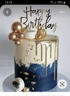 a birthday cake decorated with gold and blue icing