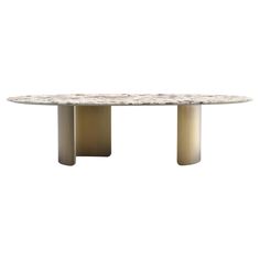 an oval marble dining table with three pedestals on each end and two circular bases at the top