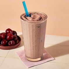 a chocolate milkshake with cherries on the side