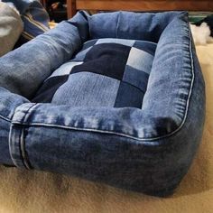 a dog bed made out of jeans on the floor