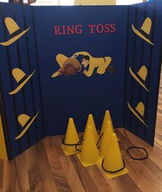 a ring toss game set up on the floor with cones around it and a sign that says ring toss