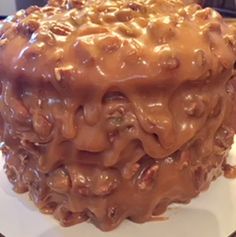 a large chocolate cake sitting on top of a white plate covered in frosted toppings