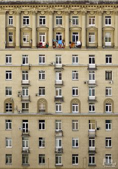 an apartment building with many windows and balconies