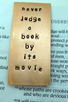 a bookmark that says never judge a book by its movie