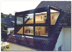 an open window on the side of a building with a view of a kitchen and dining area