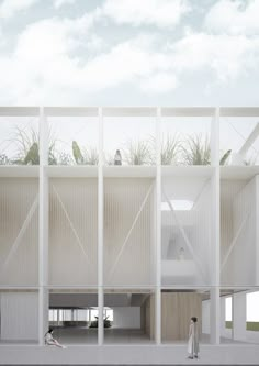 two people standing in front of a building with plants growing on the top of it