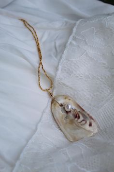 Oyster shell pendant with a fresh water pearl and swarovski crystals. Made with 14k gold filled accessories Handpicked by myself on the Eastern Shore of Maryland Gold Pearl Necklace As Gift, Gold Baroque Pearl Jewelry For Beach, Handmade Gold Shell Necklace For Wedding, Gold Shell Jewelry With Natural Stones, Gold Shell Necklace With Natural Stones As Gift, Gold Baroque Pearl Jewelry For The Beach, Gold Shell Jewelry With Pearl Pendant, Baroque Pearl Pendant Shell Necklace As Gift, Gold Shell Necklace With Natural Stones