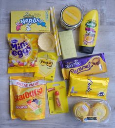 various snacks and condiments are laid out on the floor next to each other