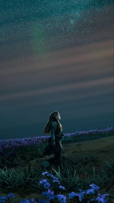 a woman standing in the middle of a field under a night sky filled with stars